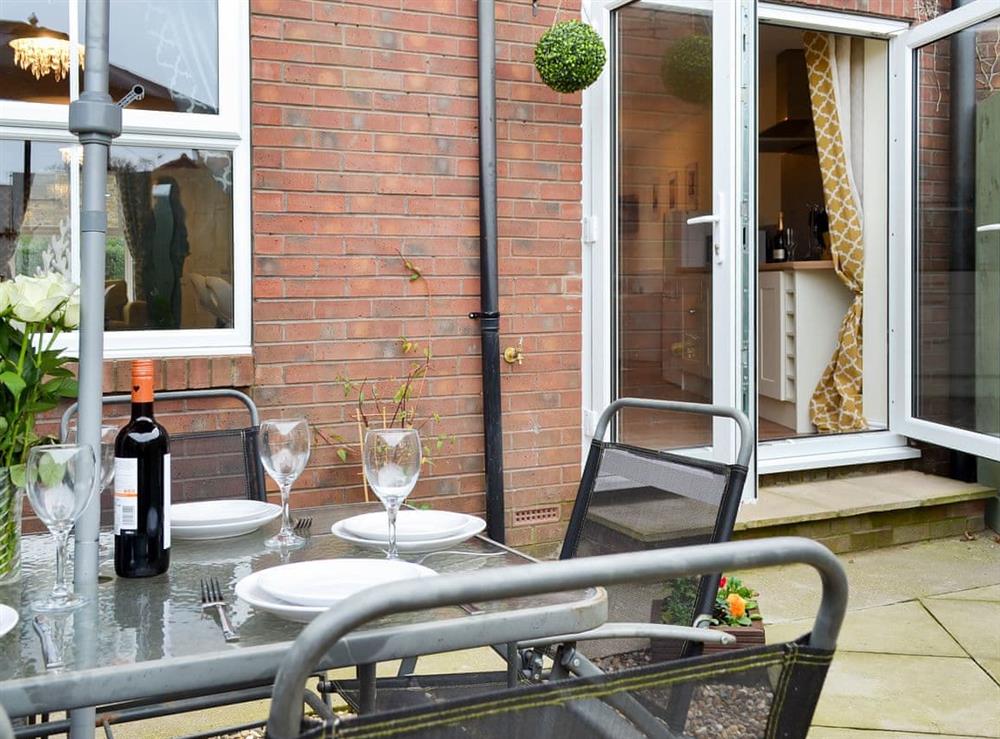 Small enclosed courtyard with sitting-out area, garden furniture and BBQ at The Horseshoes in Hornsea, North Humberside
