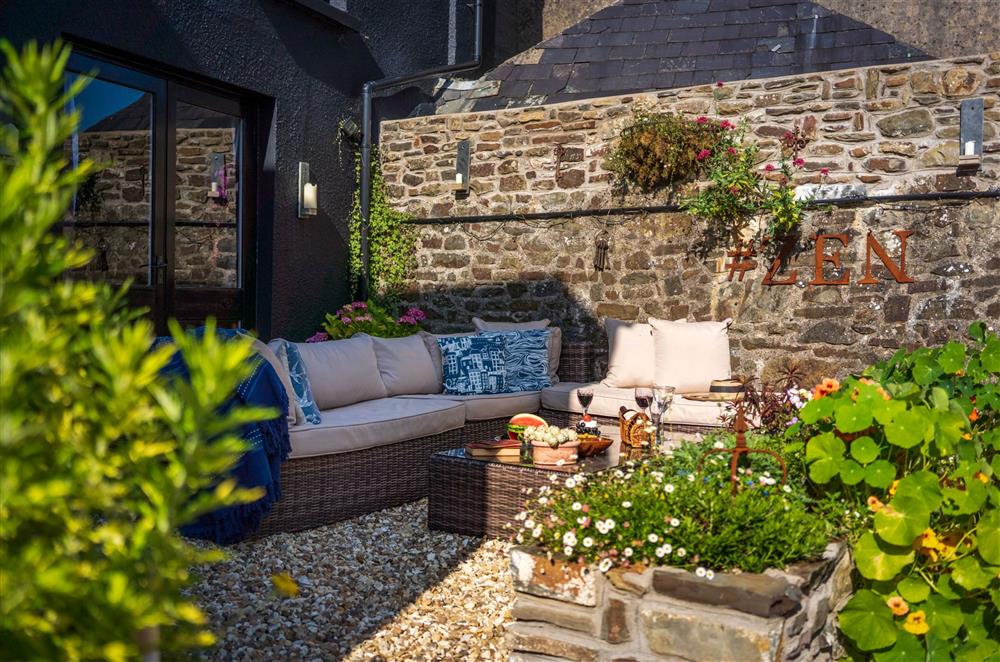 A cosy area for enjoying refreshments in the garden at The House of Black and White, Great Torrington