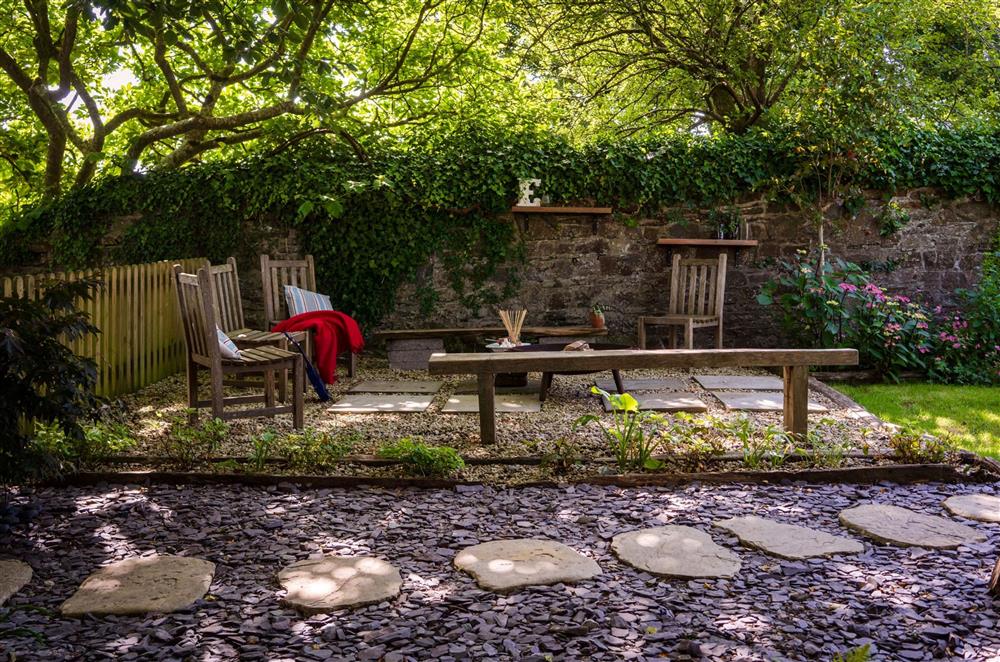 The fire pit with seating at the bottom of the enclosed garden at The House of Black and White, Great Torrington