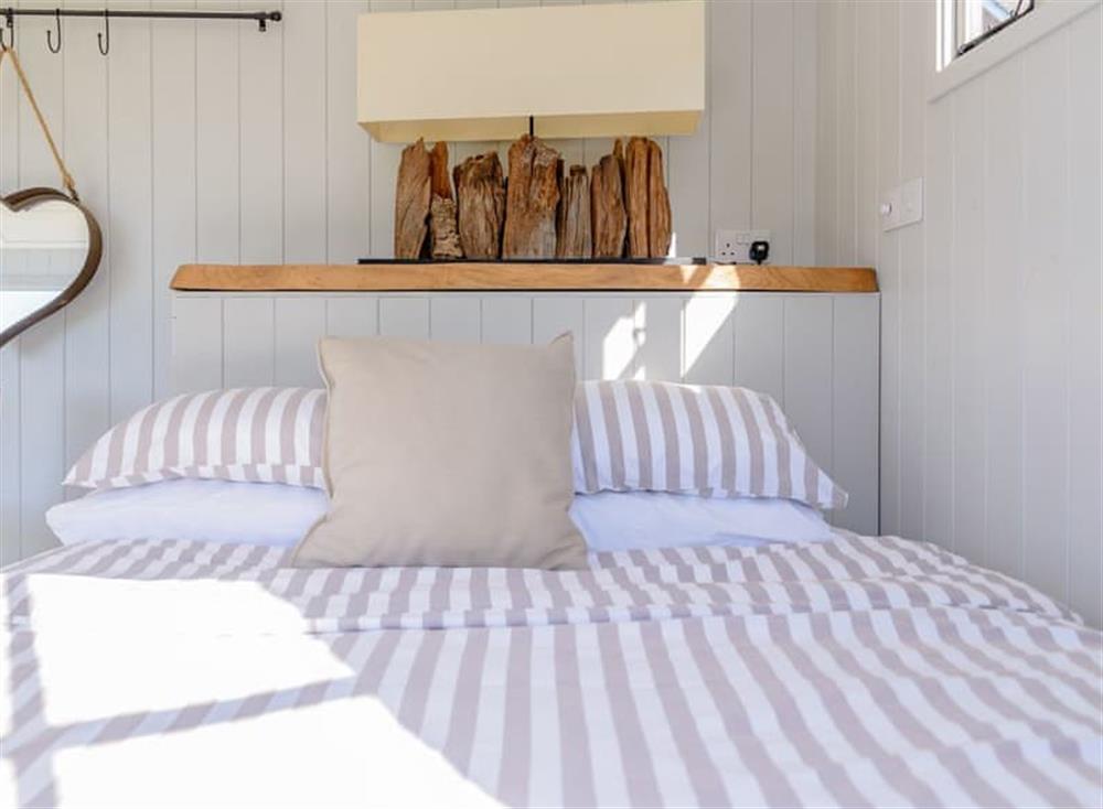 Comfortable double bed at The Hut at Hole Farm in Alderbury,  Salisbury, England