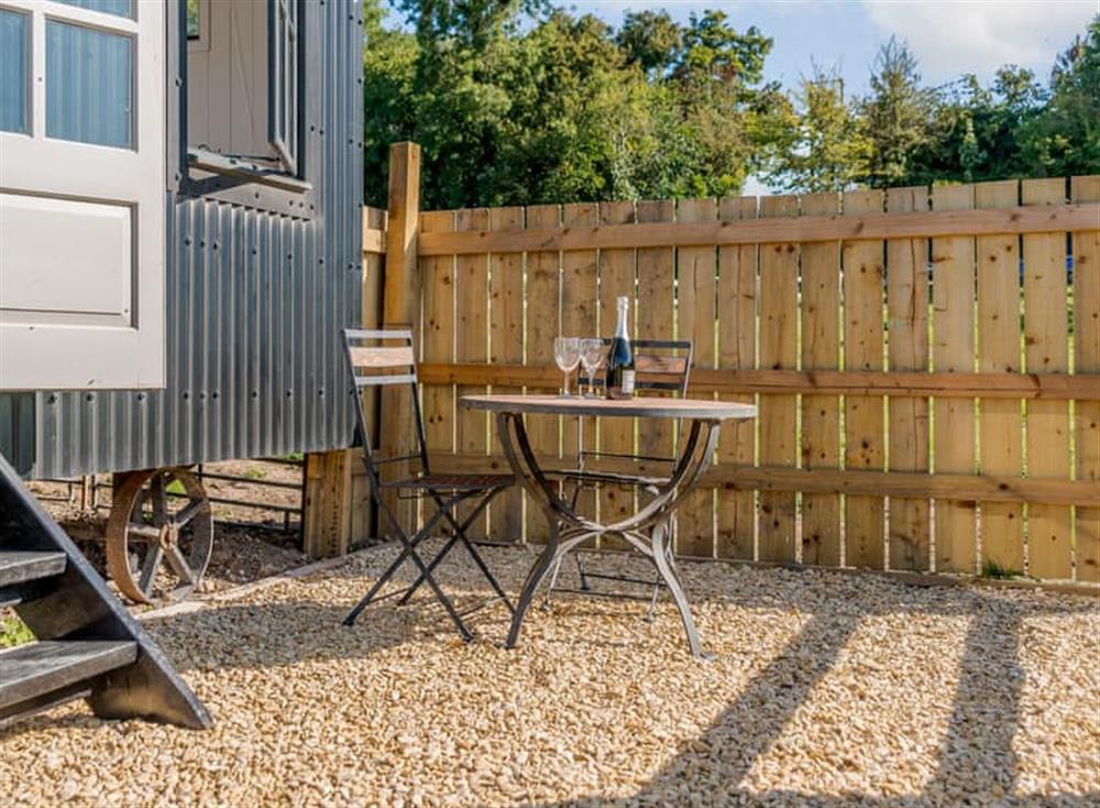 Patio area with outdoor furniture and hot tub at The Hut at Hole Farm in Alderbury,  Salisbury, England
