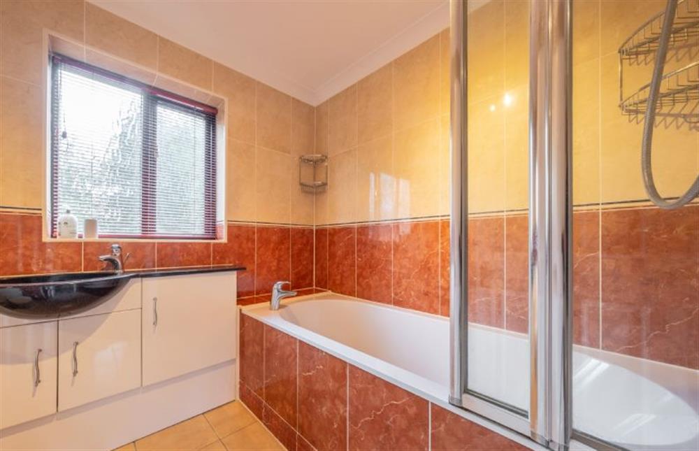 First floor: Family bathroom with bath and shower over at The Innings, Burnham Deepdale near Kings Lynn