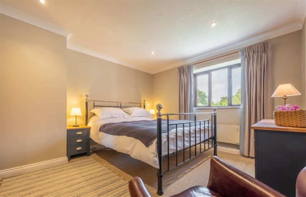 First floor: Master bedroom with king-size bed at The Innings, Burnham Deepdale near Kings Lynn