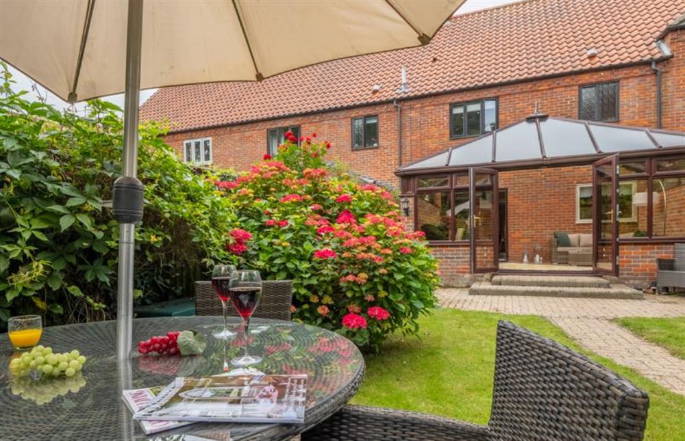 Garden seating and conservatory at The Innings, Burnham Deepdale near Kings Lynn