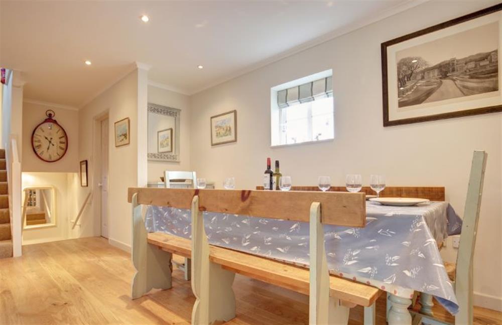 Ground floor: Dining room with stairs up and down to bedrooms at The Lifeboat House, Brancaster near Kings Lynn