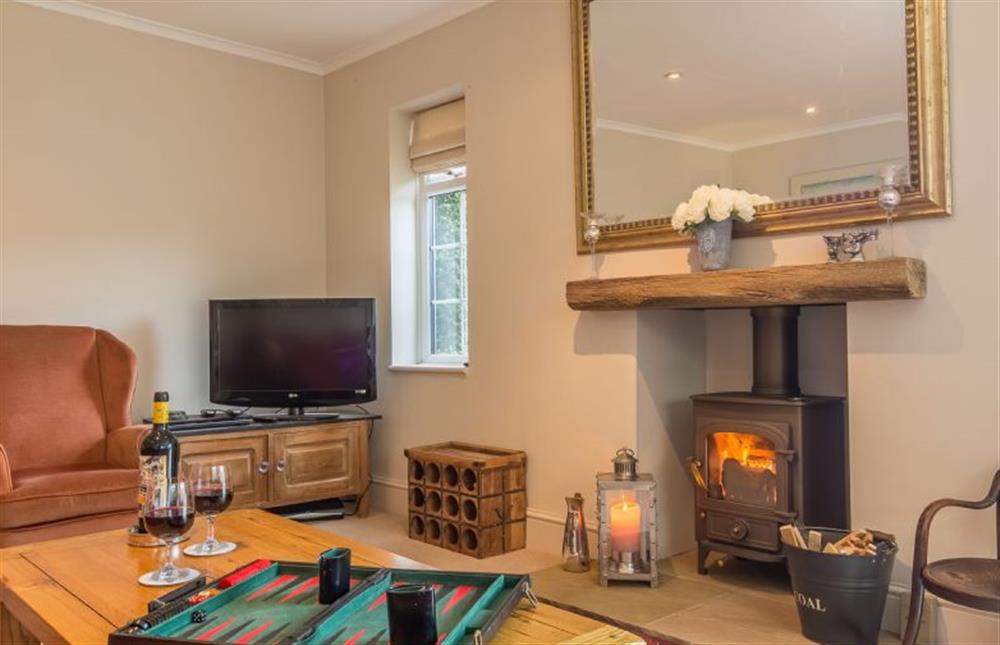 Ground floor: The Sitting room has a cosy wood burning stove at The Lifeboat House, Brancaster near Kings Lynn