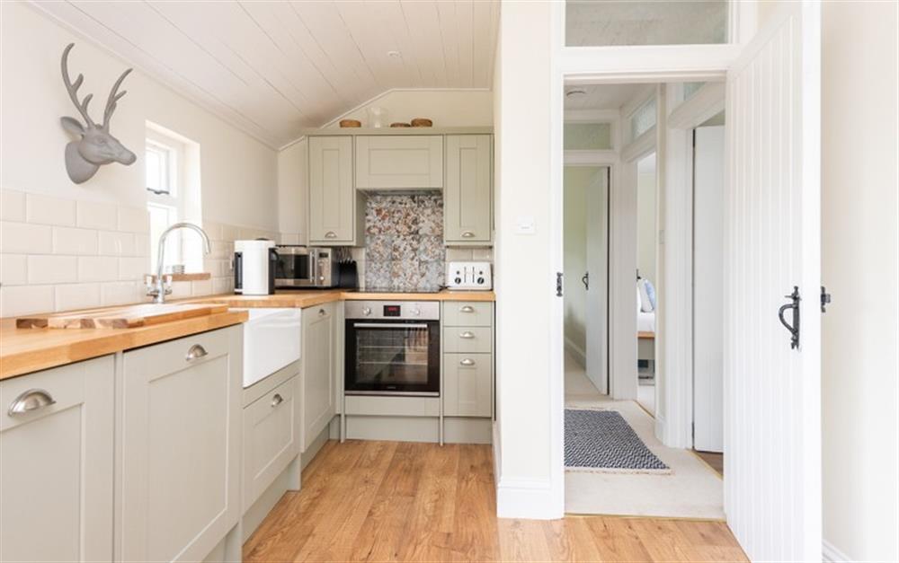 Modern kitchen with built-in appliances at The Linhay, Chipton Barton in Dittisham