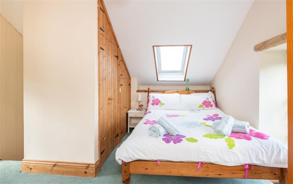The double bed fits snugly for a cosy night's sleep.  What clever use of the interesting space! at The Little Barn in Penzance