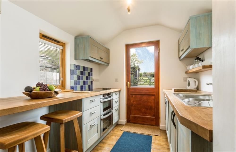 The well equipped kitchen with the breakfast bar at The Little Barn, Tintagel