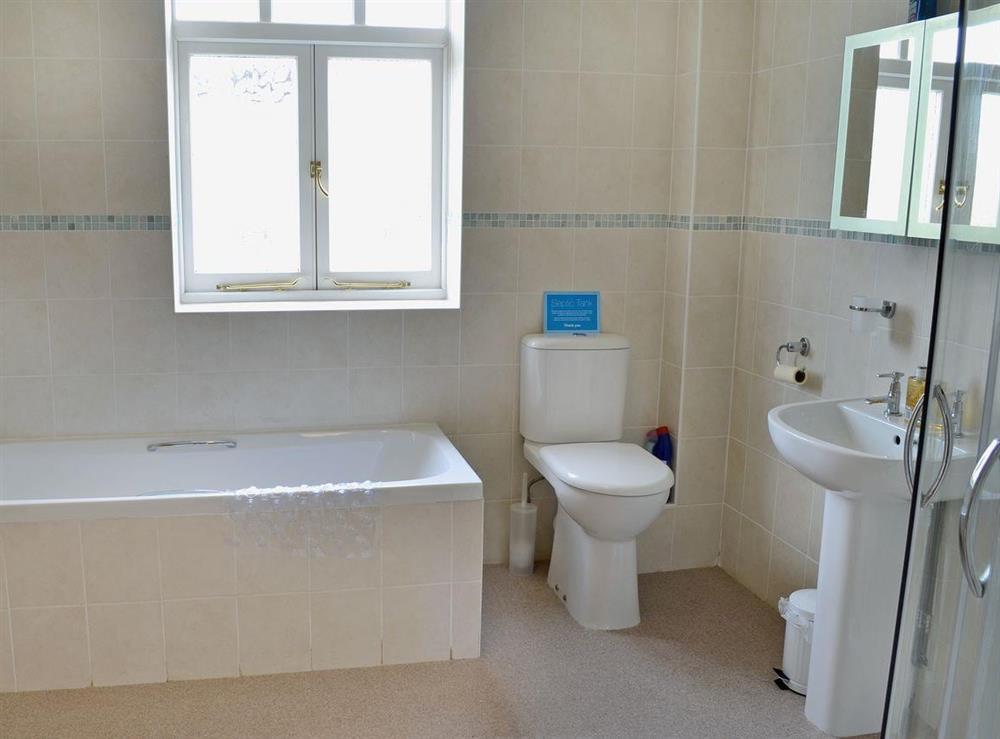 Bathroom with bath, shower cubicle and toilet at The Little Barn in Woodchurch, near Ashford, Kent