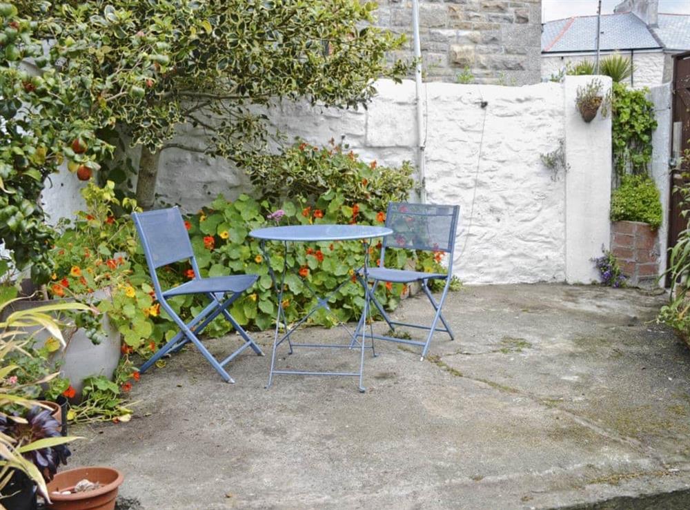 Small enclosed patio and furniture at The Little Blue House in Penzance, Cornwall