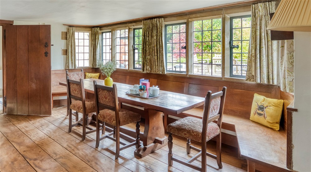 The dining table with bench seating in a large bay window (photo 2) at The Little Fleece in Stroud, Gloucestershire