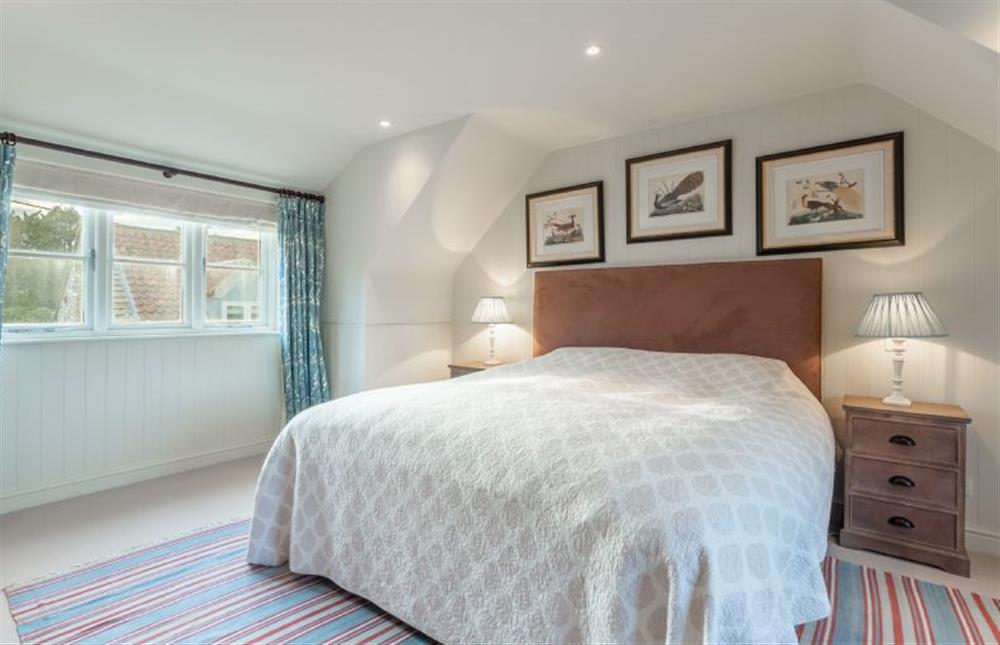 First floor: Bedroom two with a super-king size bed at The Little House, Brancaster near Kings Lynn