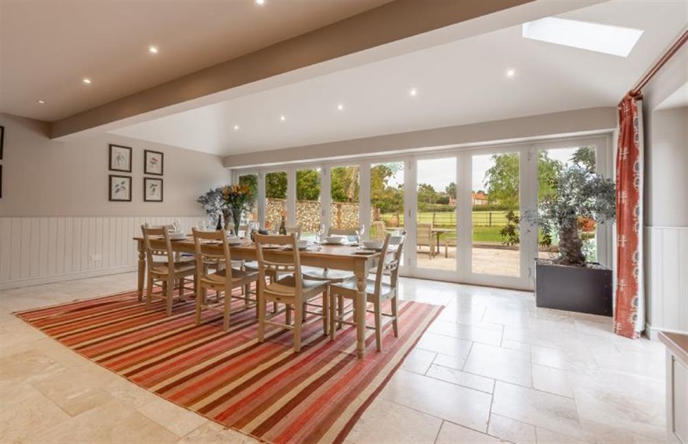 Ground floor: Dining area is light and bright with bi-fold doors to the garden at The Little House, Brancaster near Kings Lynn