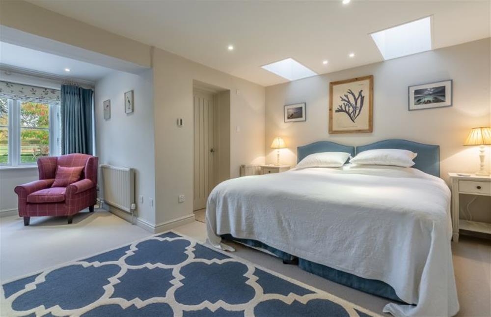 Ground floor: Master bedroom with super-king size zip-and-link bed at The Little House, Brancaster near Kings Lynn