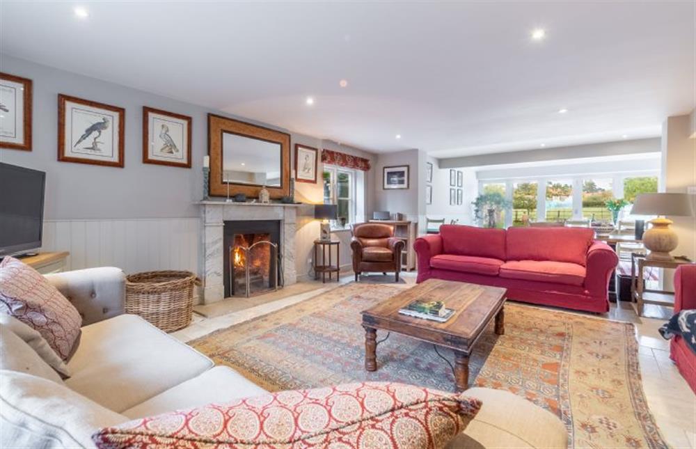 Ground floor: Sitting room with open fire at The Little House, Brancaster near Kings Lynn