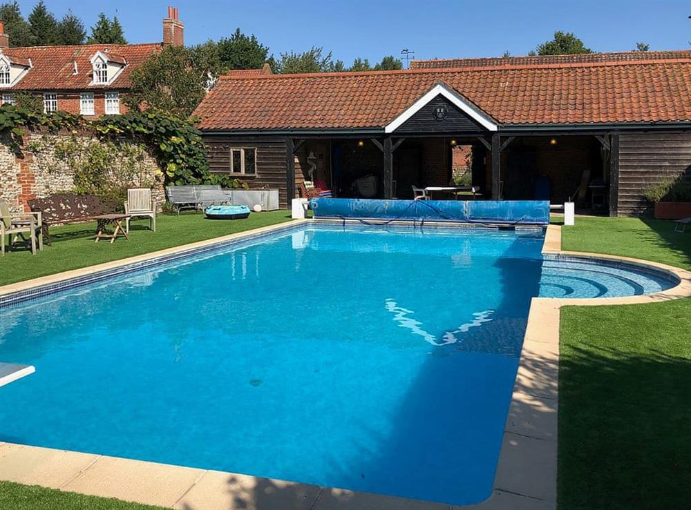 Shared heated outdoor pool at The Little House in Hempstead, near Holt, Norfolk
