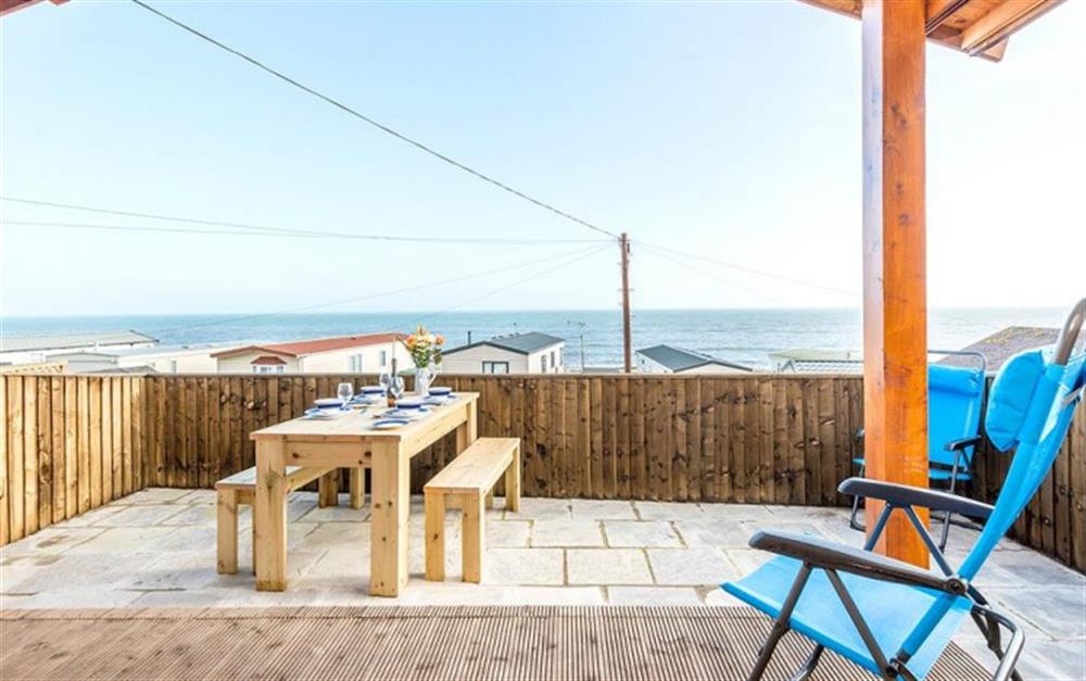 The sheltered deck area is perfect for outdoor eating and relaxing at The Lobster Pot in Lyme Regis