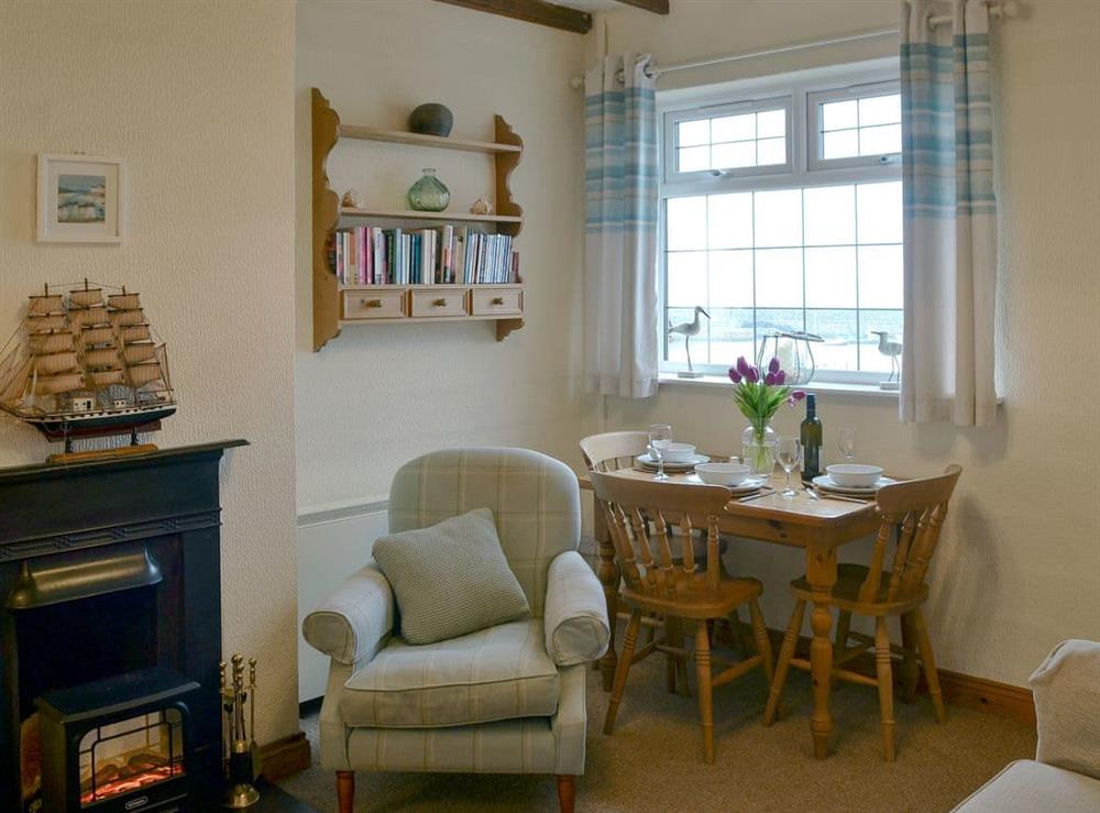 Charming living/ dining room at The Lobster Pot in Trefor, near Caernarfon, Gwynedd