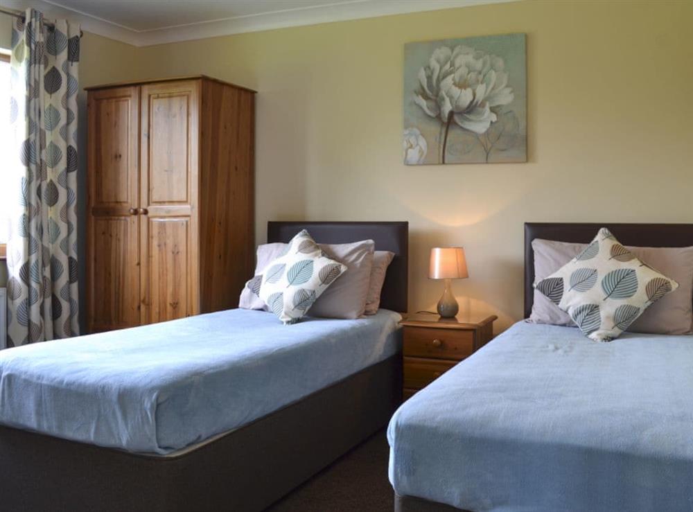 Stylish bedroom with twin beds at The Lodge in Brandesburton, near Driffield, North Humberside