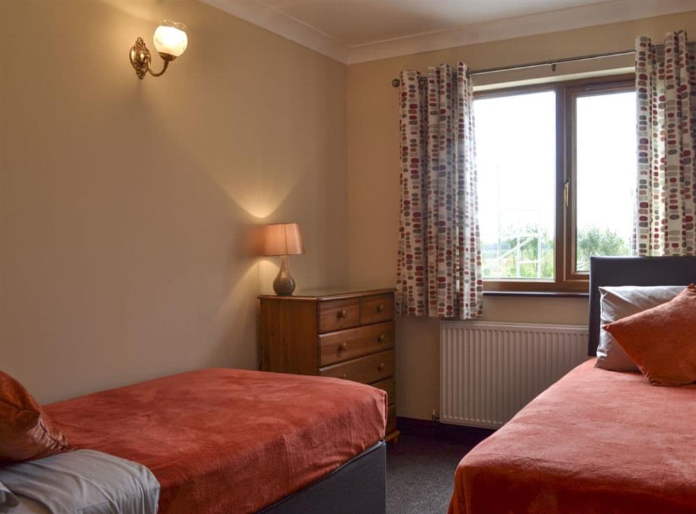 Tranquil bedroom with twin beds at The Lodge in Brandesburton, near Driffield, North Humberside