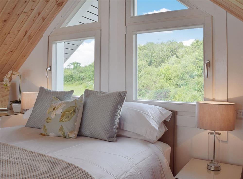 Galleried bedroom with high sloping ceiling at The Lodge in Five Roads, near Llanelli, Dyfed