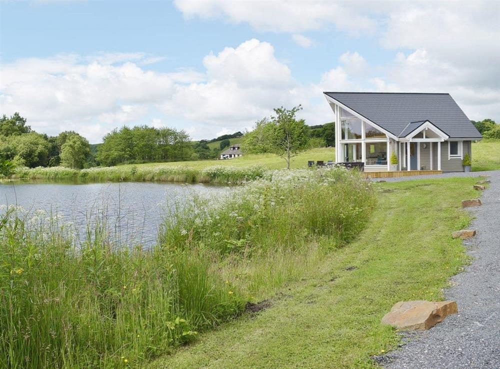 Stunning timber lodge on the edge of a private lake at The Lodge in Five Roads, near Llanelli, Dyfed