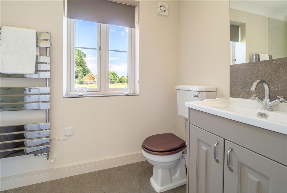 En-suite bathroom with bath and overhead shower at The Lodge, Middleton