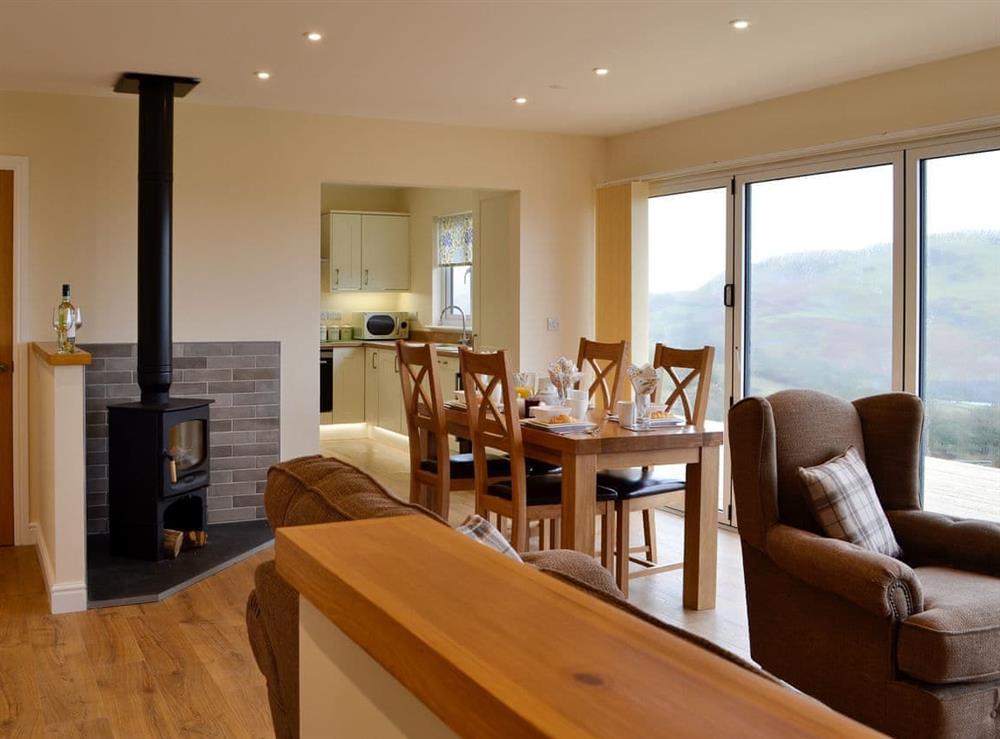 Delightful open plan living area with bi-fold doors to the decked area at Sweet Meadow Lodge, 