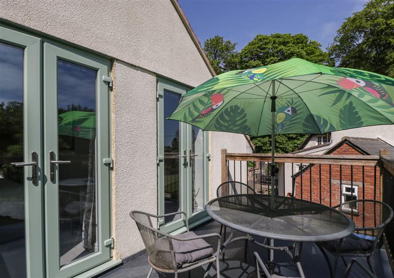 Enjoy a glass of wine on the patio at The Loft At Nordrach Lodge, Charterhouse-on-Mendip near Blagdon