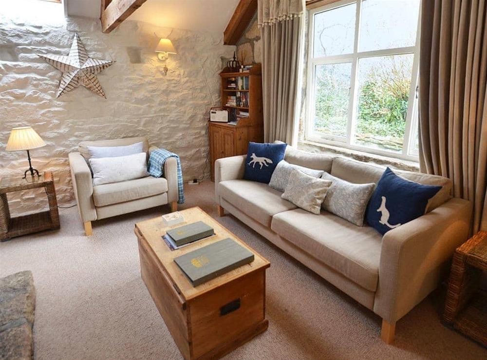 Beamed living room with whitewashed walls at The Long Barn in Godolphin Cross, Helston, Cornwall., Great Britain