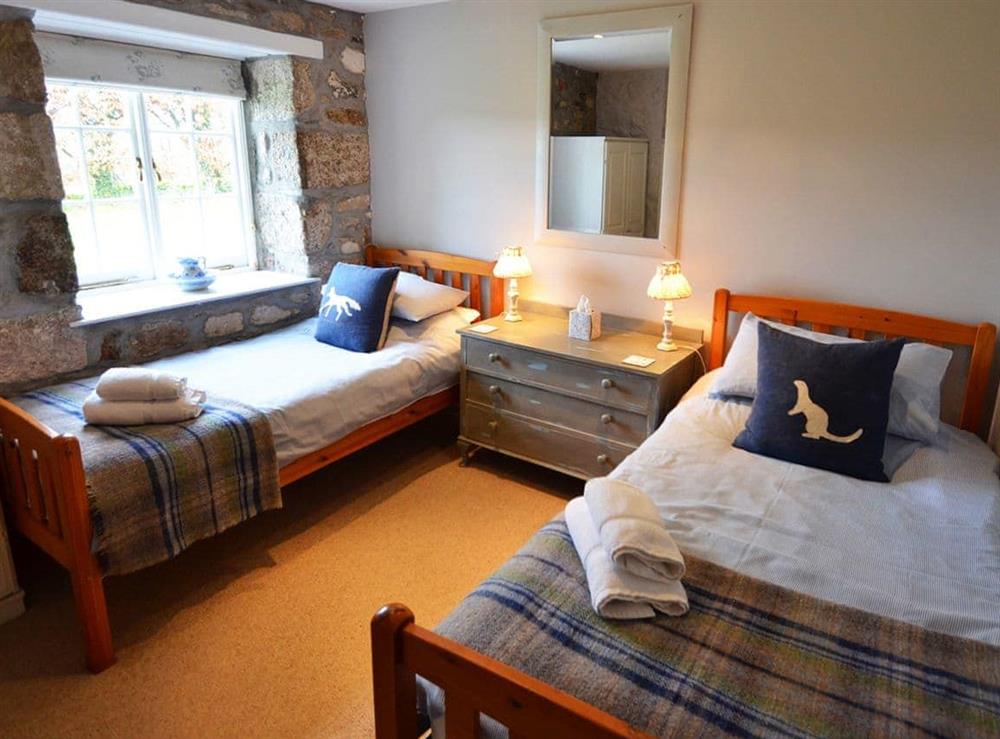 Bedroom with twin single beds at The Long Barn in Godolphin Cross, Helston, Cornwall., Great Britain