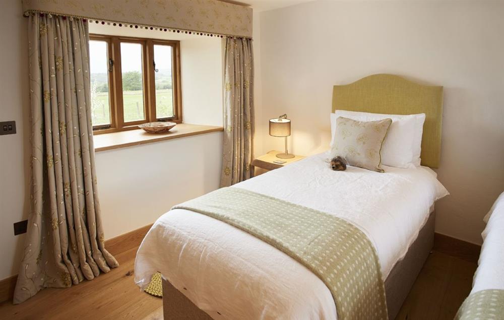 Plenty of light in the Garden bedroom with views all around at The Longbarn at Caerfallen, Ruthin