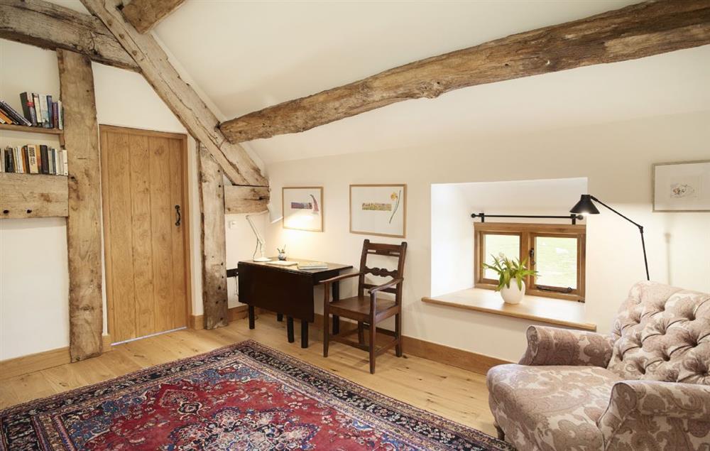 The large landing area with bathroom, writing desk and armchair at The Longbarn at Caerfallen, Ruthin