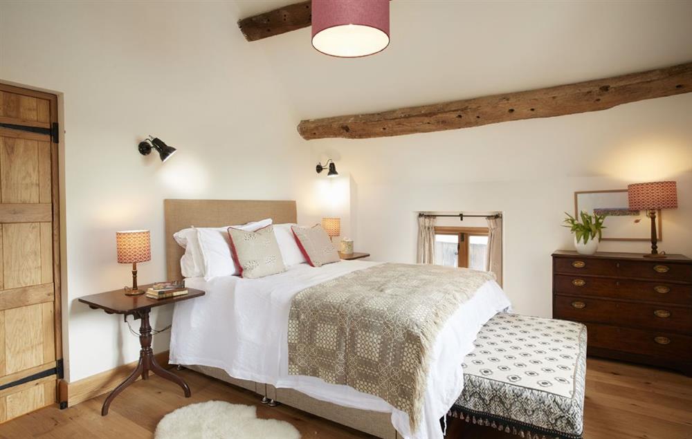 The Orchard master bedroom with 5’ king size bed and adjoining bathroom at The Longbarn at Caerfallen, Ruthin