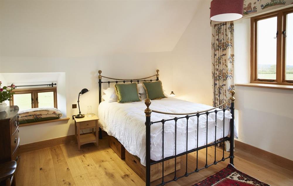 The Tudor bedroom with 5’ king size bed and en-suite shower room at The Longbarn at Caerfallen, Ruthin