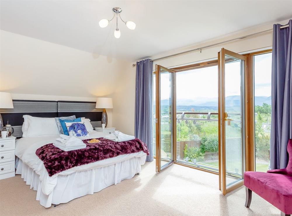 Spacious bedroom with kingsize bed at The Lookout in Aviemore, Highlands, Inverness-Shire