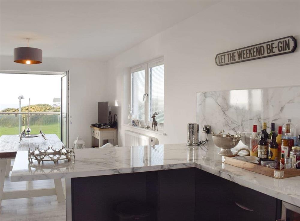 Well-equipped kitchen with dining area within the open-plan design at The Lookout in Portpatrick, Wigtownshire