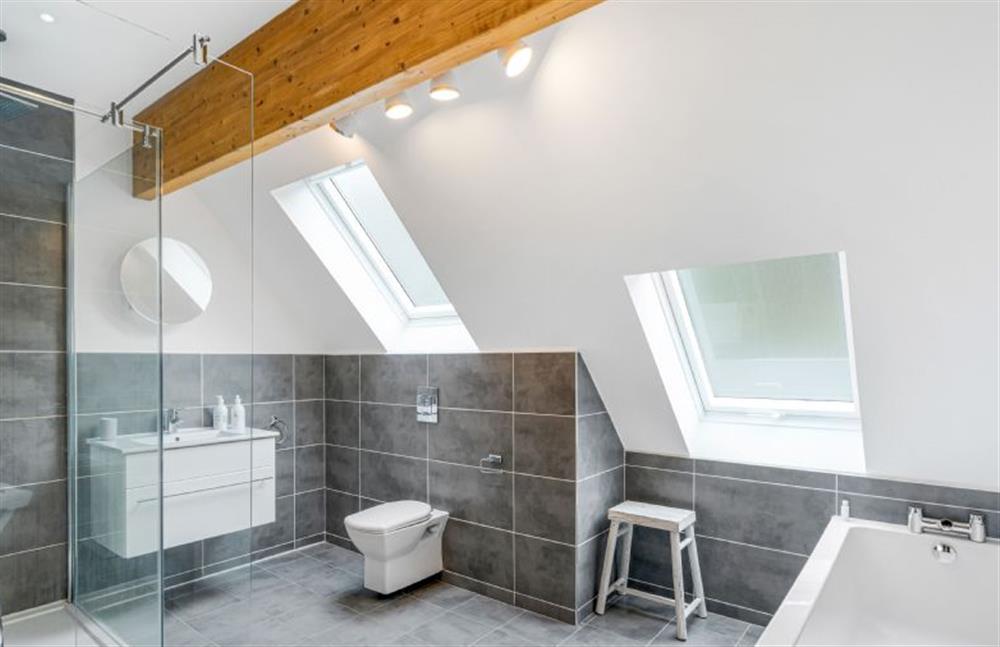 Bedroom four en-suite with bath, shower, wash basin and WC at The Lookout, Portreath