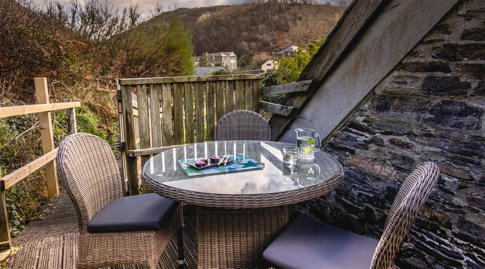 Seating on the decked area by the front door at The Lugger in Boscastle, Cornwall