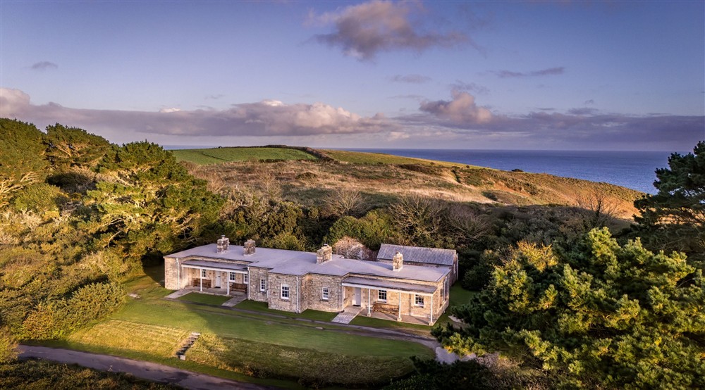 An aerial view of The Lieutenants Quarter, The Majors Quarter and The Captains Quarter, and the headland and sea beyond, Cornwall at The Major's Quarter in Roseland, Cornwall
