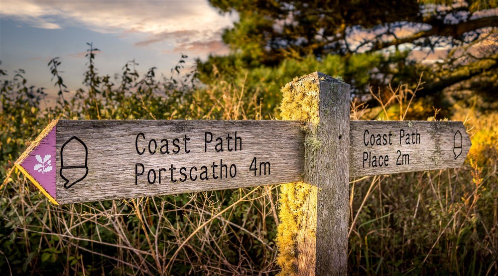 The coast path sign near the holiday cottages on St Anthony Head, Cornwall at The Major's Quarter in Roseland, Cornwall