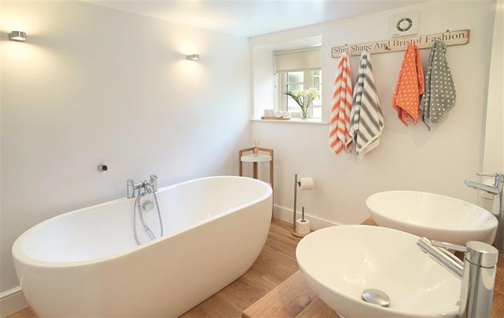 Ground floor: Bathroom with wc, bath with handheld shower and twin basins at The Maltings, Trunch