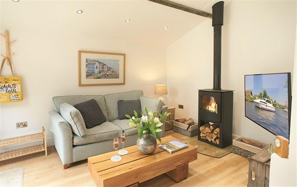 Ground floor: Sitting room with wood burning stove at The Maltings, Trunch