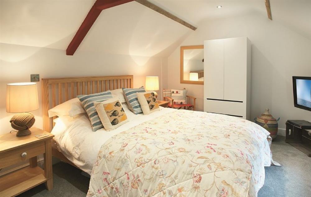 Mezzanine bedroom on upper level with king-size bed at The Maltings, Trunch