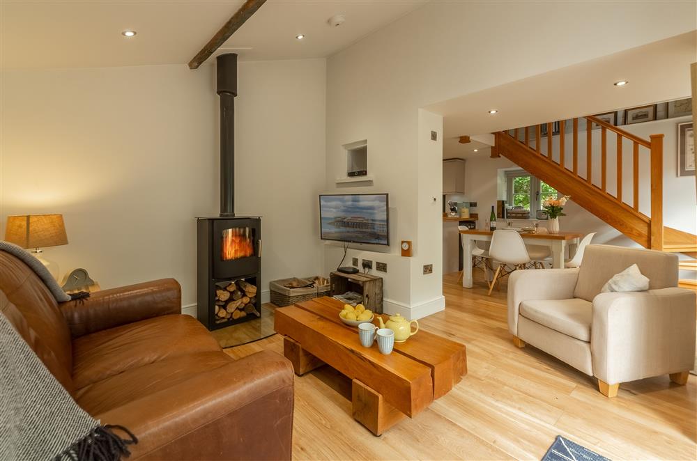 Sitting room with wood burning stove, flows into dining area and kitchen at The Maltings, Trunch