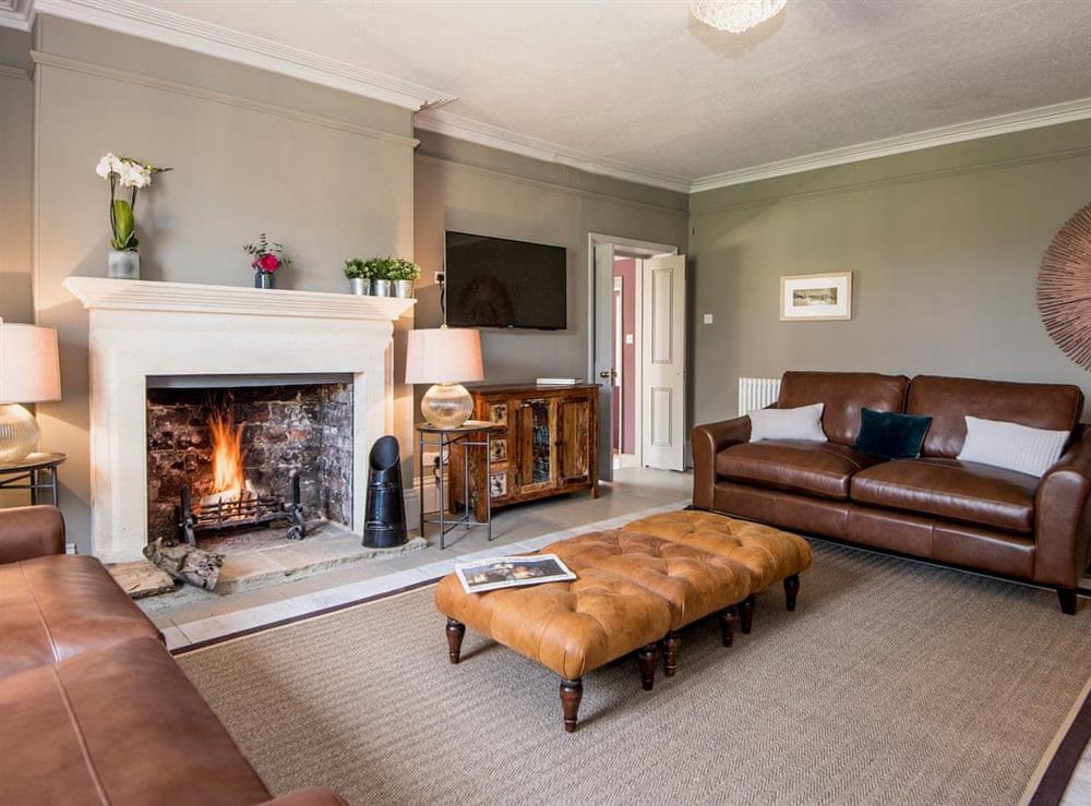 Charming and warm living room with open fire at The Manor House in Syderstone, near Fakenham, Norfolk