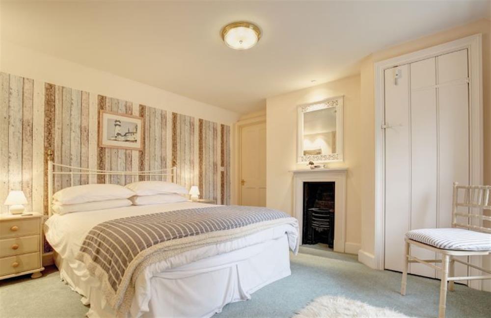 The Manse: Bedroom two with a double bed, built in wardrobe and a feature fireplace at The Manse, South Creake near Fakenham