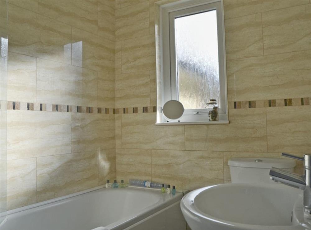 Bathroom with shower over bath at The Meadow Flat in Shanklin, Isle of Wight