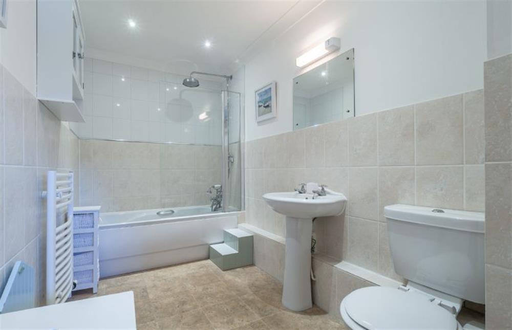 Family bathroom with bath with shower over, wash basin and WC at The Meadows Dairy, Bawdsey